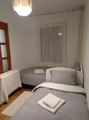 a bedroom with two beds and a window at GO 2 Apartment in Belgrade