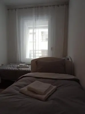 a bed with towels on it in a room with a window at GO 2 Apartment in Belgrade