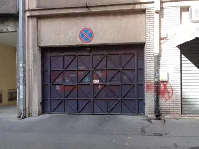 a blue garage door with a x sign on it at GO 2 Apartment in Belgrade