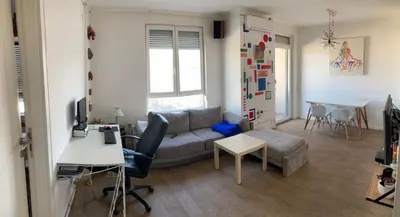 a living room with a couch and a table at Forest View in Belgrade