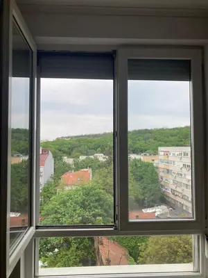 a window with three views of a city at Forest View in Belgrade
