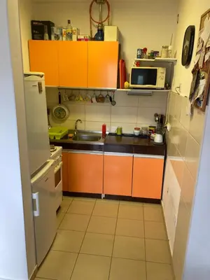 a small kitchen with orange cabinets and a sink at Forest View in Belgrade