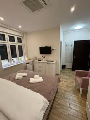 a bedroom with a bed with two towels on it at Stefy Lux Apartments in Belgrade