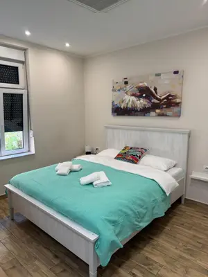 a bedroom with a large bed with towels on it at Stefy Lux Apartments in Belgrade