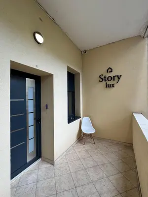 a waiting room with a door and a white chair at Stefy Lux Apartments in Belgrade