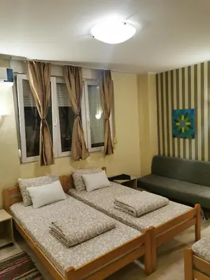 a living room with two beds and a couch at Agape Downtown in Belgrade