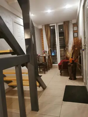 a hallway with a staircase and a living room at Agape Downtown in Belgrade