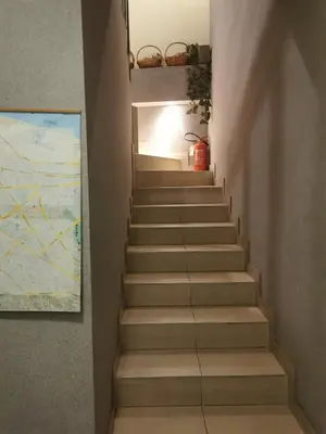 a staircase leading up to a room with a map at Agape Downtown in Belgrade