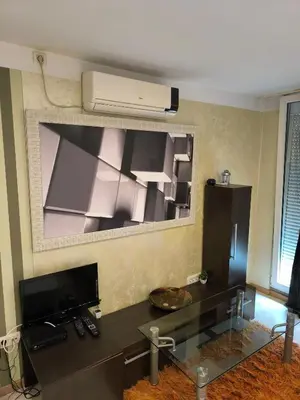 a living room with a glass desk and a air conditioner at Agape Downtown in Belgrade