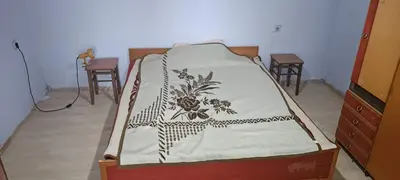 a bed in a room with two tables and chairs at Happy Home in Starčevo