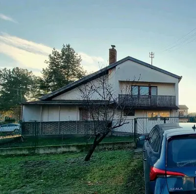a house with a car parked in front of it at Happy Home in Starčevo