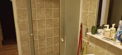 a bathroom with a shower stall and a mirror at Happy Home in Starčevo