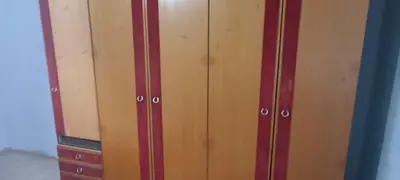 a pair of wooden cabinets in a room at Happy Home in Starčevo