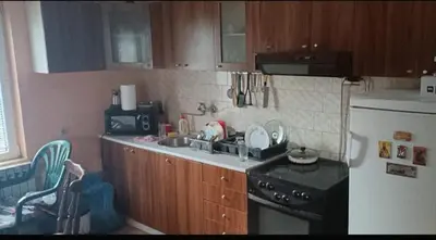 a kitchen with a sink and a stove and a refrigerator at Happy Home in Starčevo