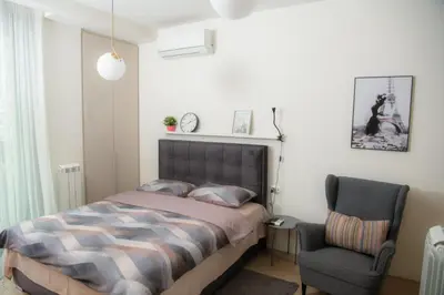 a bedroom with a bed and a chair at Belgrade Waterfront Metropolitan 2 in Belgrade