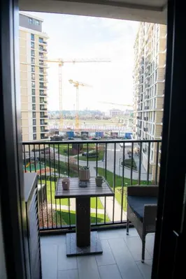 a balcony with a table and a view of a building at Belgrade Waterfront Metropolitan 2 in Belgrade