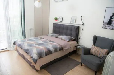 a bedroom with a bed and a chair in it at Belgrade Waterfront Metropolitan 2 in Belgrade