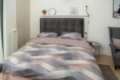 a bedroom with a bed with a camouflage bedspread at Belgrade Waterfront Metropolitan 2 in Belgrade