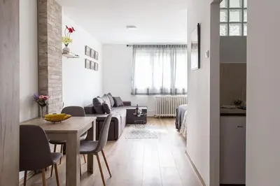 a living room with a table and a couch at Apartman Nelly - Fontana in Fontana