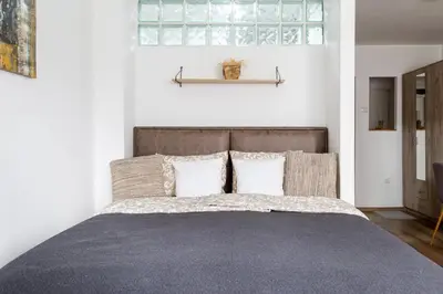a bedroom with a bed with two pillows and a window at Apartman Nelly - Fontana in Fontana