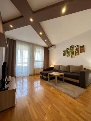 a living room with a couch and a table at Nevena Belville Apartments in Belgrade