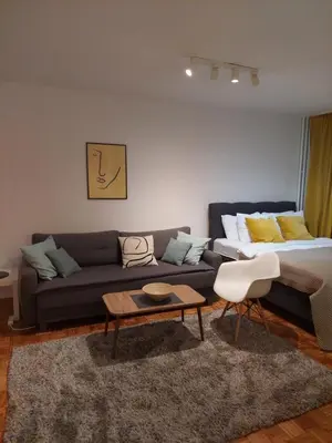 a living room with a couch and a bed at Dolce vita 1 in Belgrade