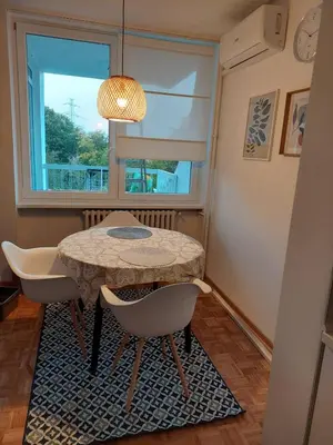a table and chairs in a room with a window at Dolce vita 1 in Belgrade