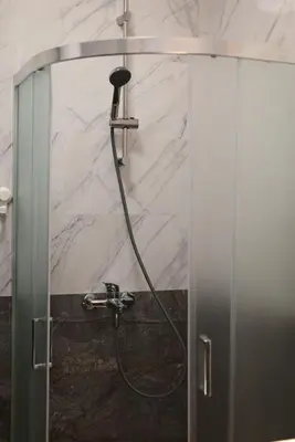 a shower in a bathroom with a glass door at K2 Apartmani in Belgrade