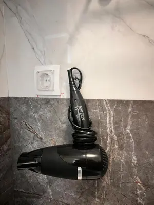 a black cordless phone sitting on top of a counter at K2 Apartmani in Belgrade