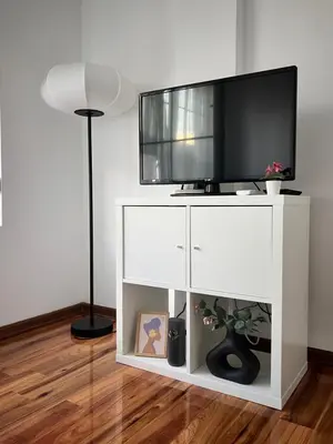 a white entertainment center with a flat screen tv on top at K2 Apartmani in Belgrade