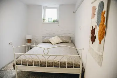 a bedroom with a white bed in a white room at Vila Kraljev Breg Fruška Gora Pool and Padel in Čortanovci
