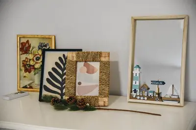 a shelf with pictures and a mirror on a wall at Vila Kraljev Breg Fruška Gora Pool and Padel in Čortanovci
