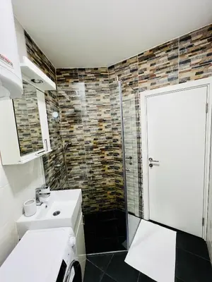a bathroom with a glass shower and a sink at Iskra Apartment in Belgrade