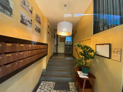 a hallway with stairs and a potted plant at Iskra Apartment in Belgrade