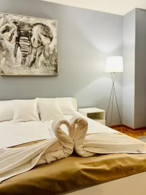 a bed with a heart shaped towel on it at Iskra Apartment in Belgrade