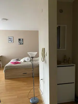 a bedroom with a bed and a phone in it at Apartman Stojadinović in Ruma