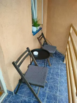 two chairs and a table on a balcony at Apartman Stojadinović in Ruma