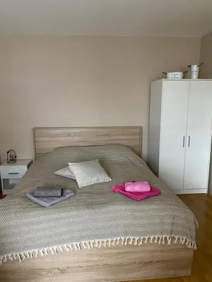 a bedroom with a bed with two towels on it at Apartman Stojadinović in Ruma