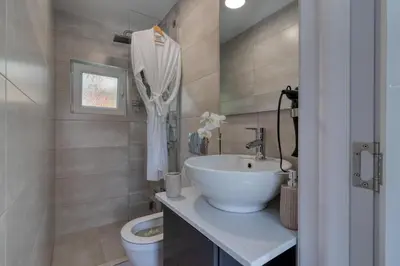 a bathroom with a sink and a toilet at Bungalow Lux in Novi Banovci