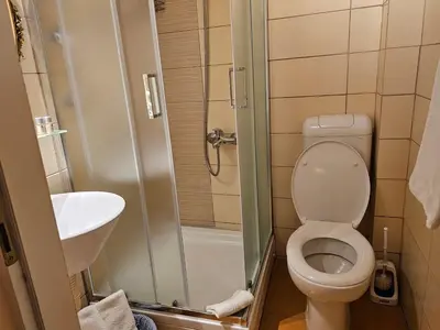 a small bathroom with a toilet and a sink at VANSVEL Boutique Apartment 7 in Belgrade