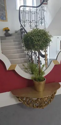a potted plant on a table next to a staircase at VANSVEL Boutique Apartment 7 in Belgrade