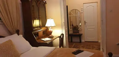 a bedroom with a bed and a lamp and a mirror at VANSVEL Boutique Apartment 7 in Belgrade