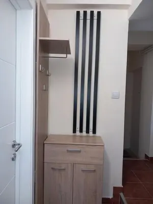a small wooden cabinet in a room with a wall at Libero78 in Vračar (historical)