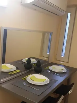 a table with plates on it with a mirror at Libero78 in Vračar (historical)