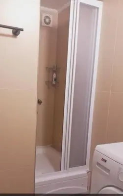 a shower with a glass door next to a toilet at Libero78 in Vračar (historical)