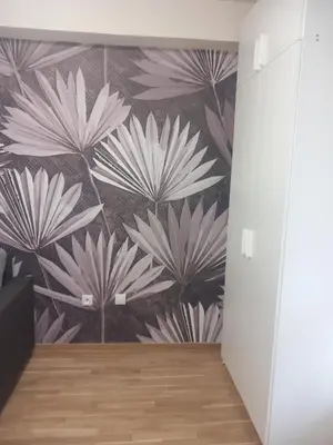 a hallway with a wall mural of white flowers at Libero78 in Vračar (historical)