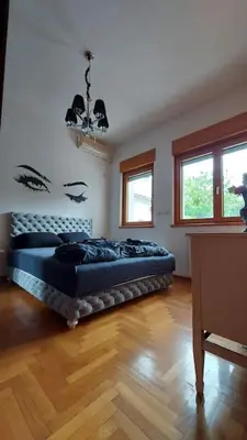 a bedroom with a bed in the middle of a room at Turquoise orange, the art of vacation in Belgrade in Vračar (historical)