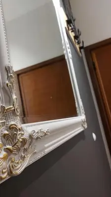 a mirror hanging on a wall next to a window at Turquoise orange, the art of vacation in Belgrade in Vračar (historical)