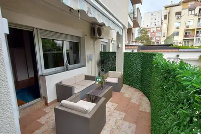 an outdoor patio with couches and chairs on a building at Turquoise orange, the art of vacation in Belgrade in Vračar (historical)