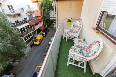 an apartment balcony with two chairs and a street at Apartment Lilian in Belgrade